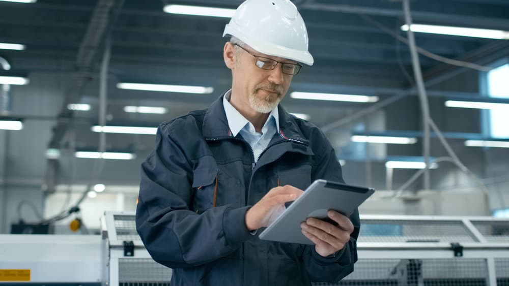 Older Engineer Taking Looking at Scheduling App