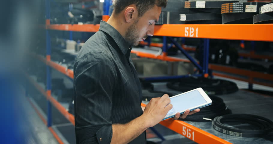 Worker Taking Inventory Of Products