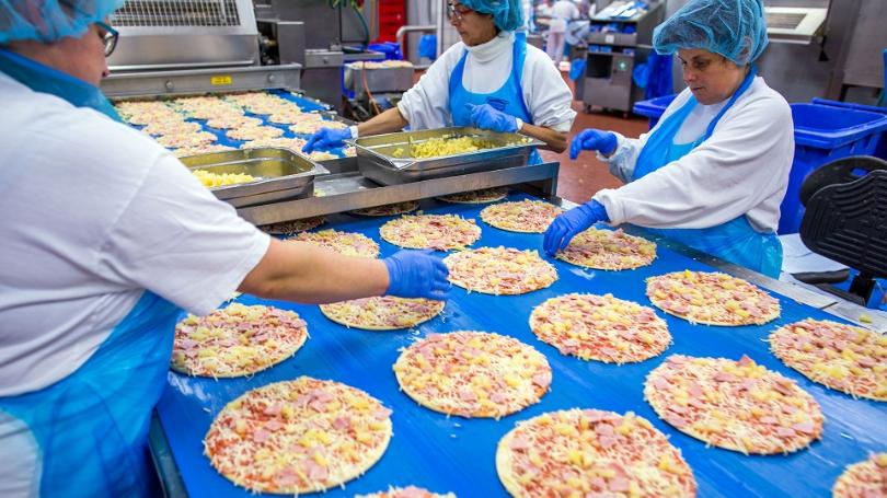 Food Industry Workers Preparing Pizza