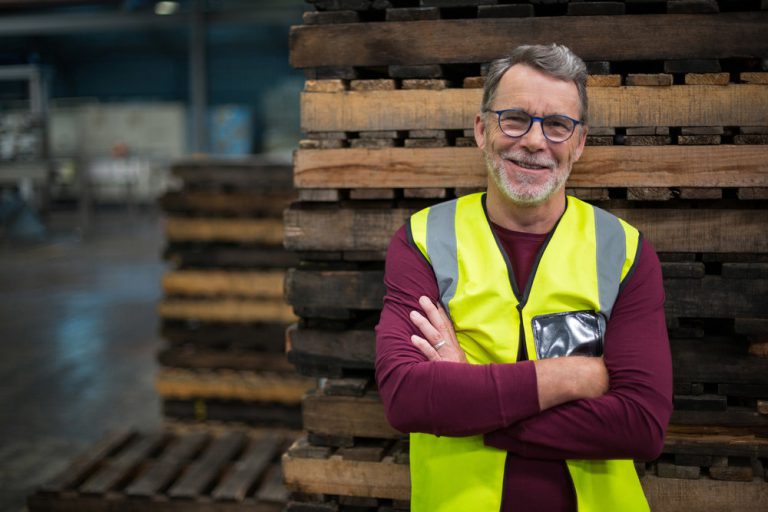 Industrial Worker Standing Next To Wooden Pallets; Job Bidding; Shift Bidding
