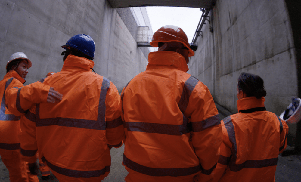 Construction Workers Walking To Their Site Together