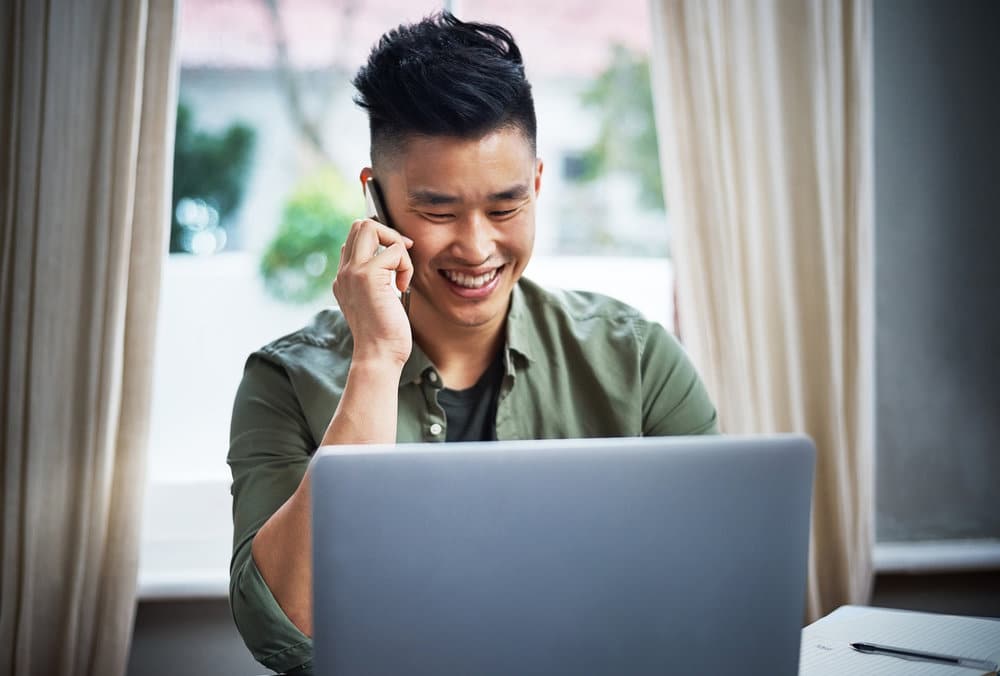 Young Worker Smiling While Talking On The Phone