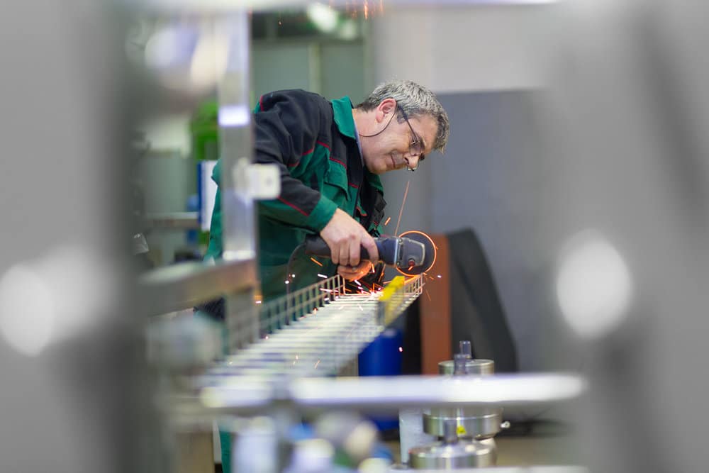 Manufacturing Worker Using An Electric Hand Saw