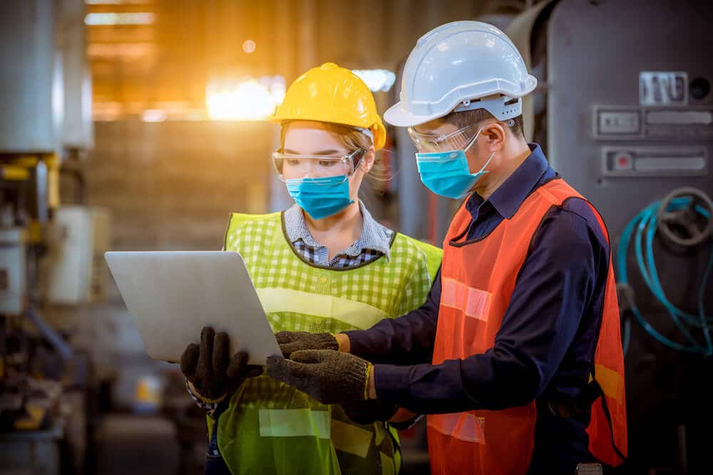 Two Industrial Employees Working On a Project Together