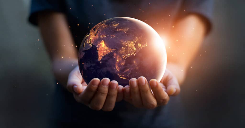 Person Holding A Globe In Their Hands