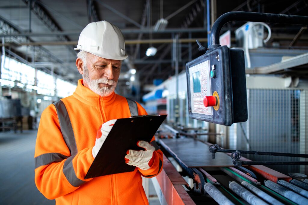 Older Engineer Taking Notes About Machinery