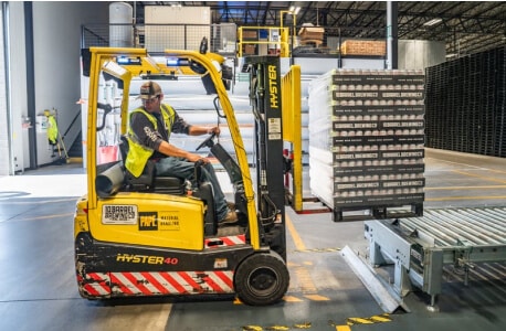 Man Running a Manufacturing Machine to Move and Lift Product