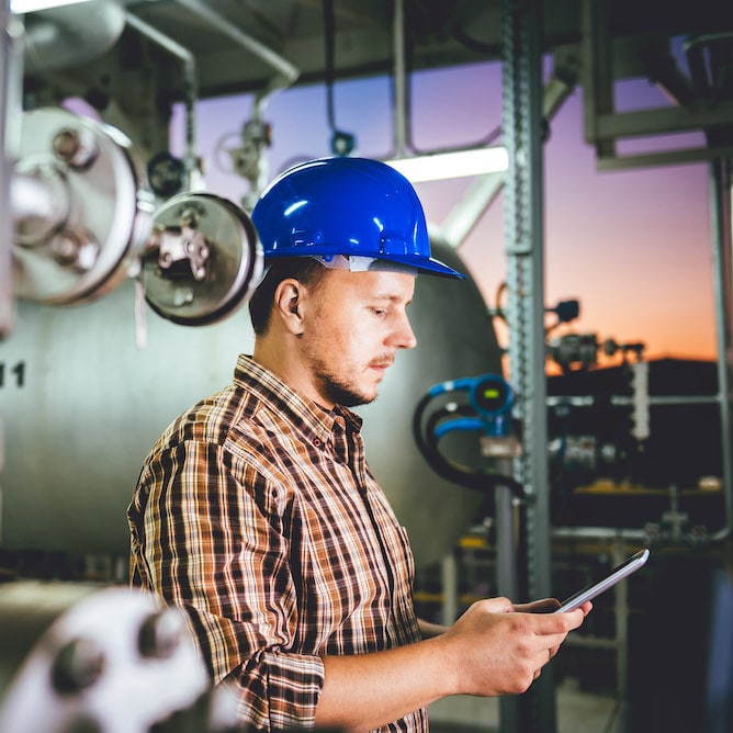 Worker In Hard Hat On Tablet