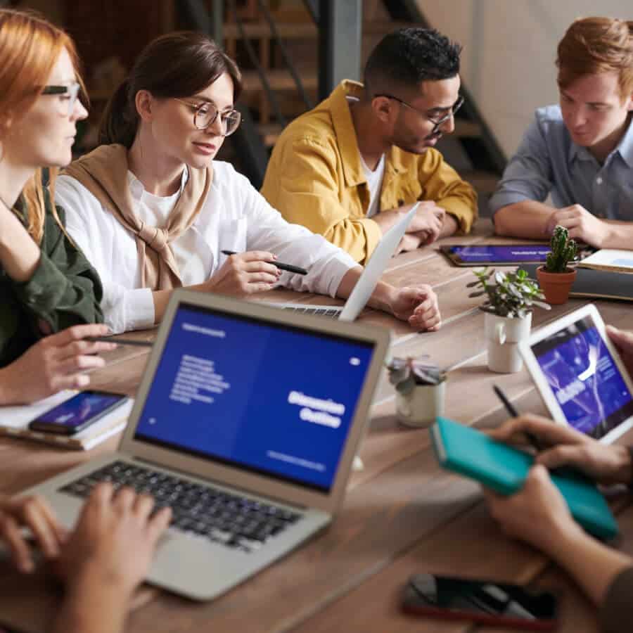 Group of People Having a Business Meeting With Laptops and Tablets