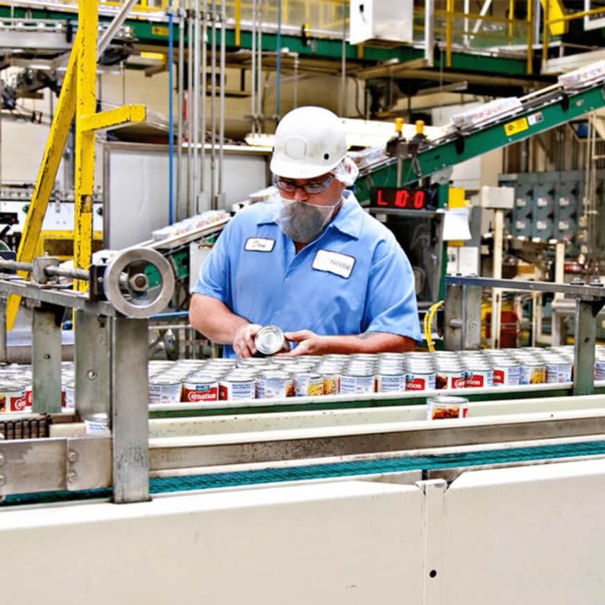 Food Processing Worker Checking Cans