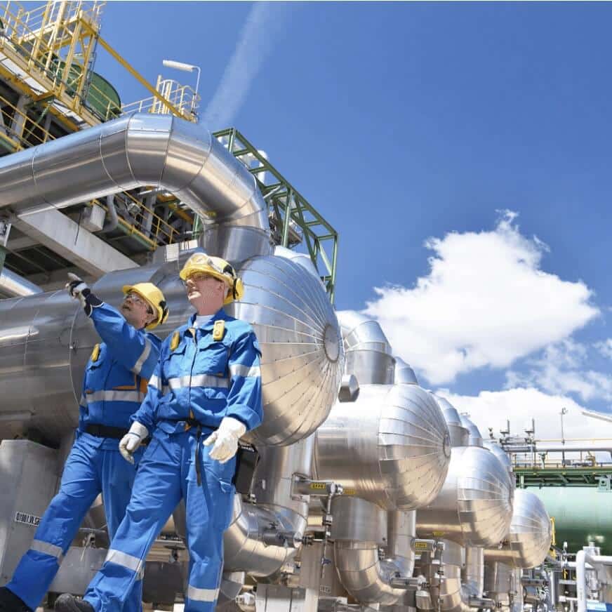 Two Oil Plant Workers Walking Around the Facility