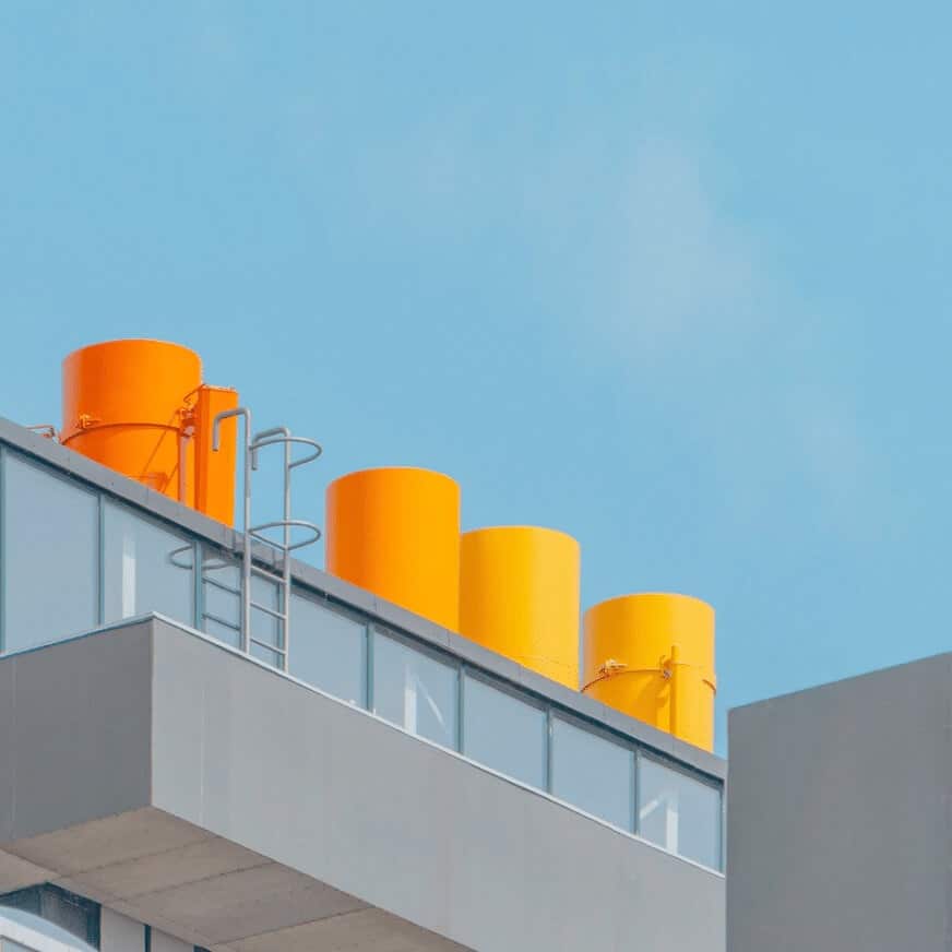 Four Orange Tanks on Top of a Manufacturing Facility