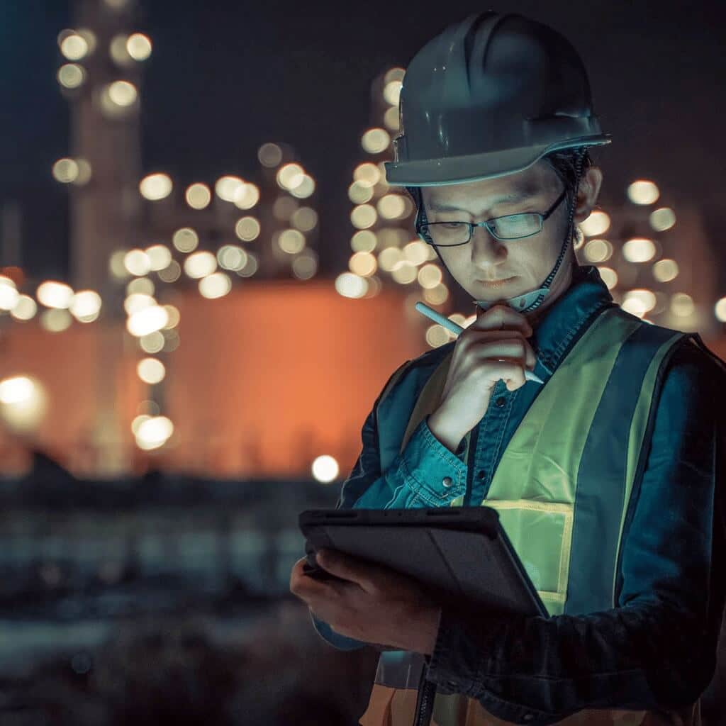 Construction Worker Looking at a Tablet Contemplating