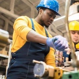 Male Engineer Wearing a Hardhat Doing Work in the Factory