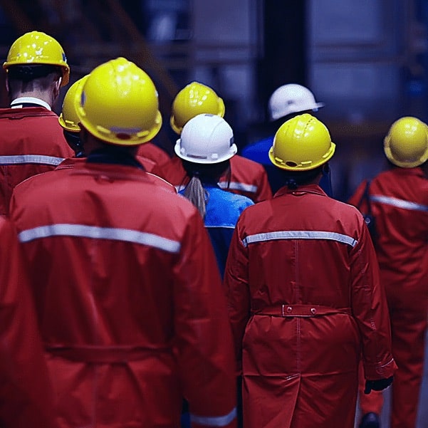 Factory Workers Walking Outside With Hardhats on