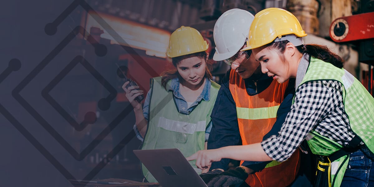 3 people in hard hats looking at an ipad trying to reduce labor costs