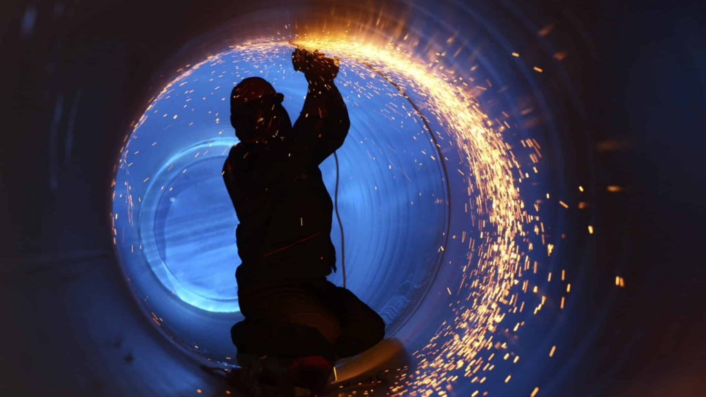 A,worker,works,inside,a,pipe,on,a,pipeline,construction, Skills Management Software