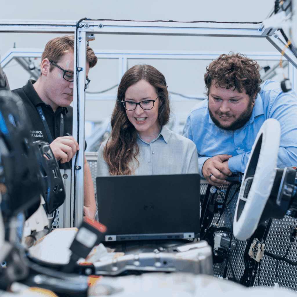 Automotive Manufacturing, 3 engineers working on car assembly