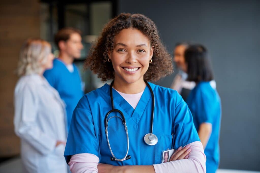 Confident,happy,woman,nurse,smiling,with,crossed,arms,with,healthcare, Nurse Scheduling Software