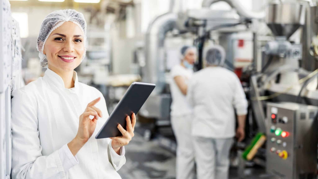 Portrait,of,female,food,factory,inspector,using,tablet,and,smiling, Scalable Food Manufacturing Software