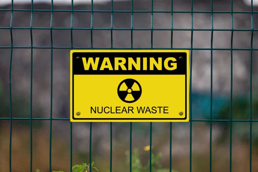 black and yellow warning nuclear waste sign on fence