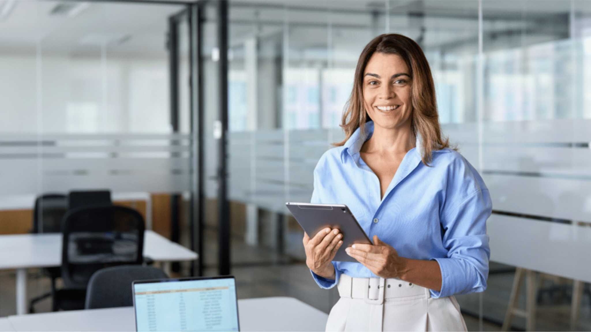 HR Woman with iPad and Laptop Demonstrating HR Integrations