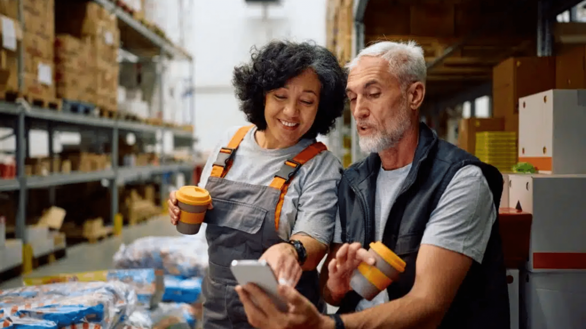 Happy,warehouse,worker,and,her,colleague,using,smart,phone,while, Communication In The Workplace