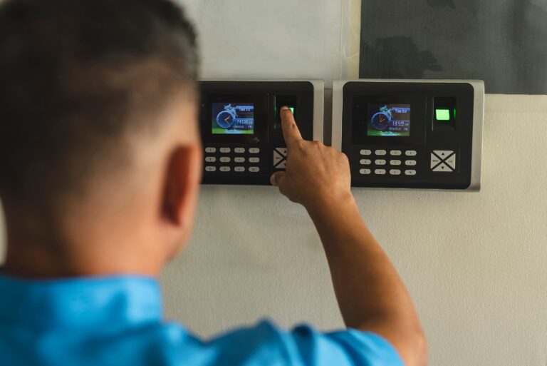 A,janitor,or,clerk,clocking,in,on,a,fingerprint,biometric, time and attendance, time accuracy, payroll errors