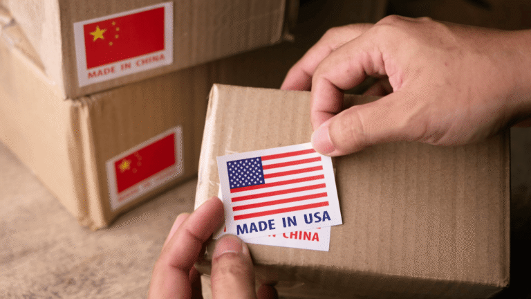 Reshoring Manufacturing From China To Usa; Cardboard Boxes With A Hand Applying Stickers