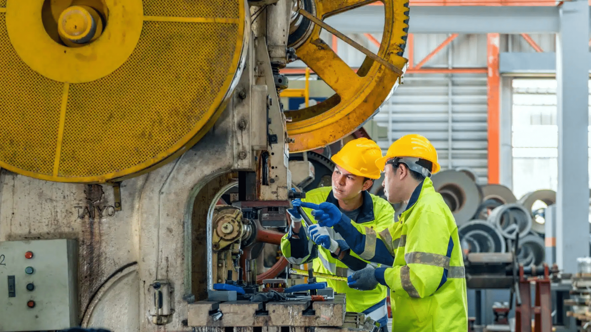 Industrial,manufacturing,workers,wearing,safety,gear,operating,heavy,machinery,in, Manufacturing Talent Acquisition, Manufacturing Upskilling