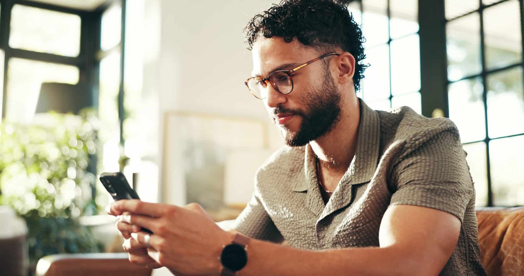 Home,,scroll,and,man,on,sofa,,smartphone,and,message,to, how to call off work