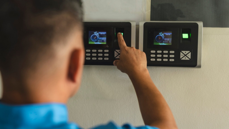 A,janitor,or,clerk,clocking,in,on,a,fingerprint,biometric, time and attendance, time accuracy, payroll errors