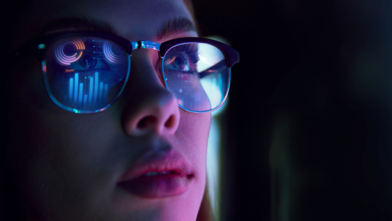 Woman In Glasses Viewing Workforce Analytics