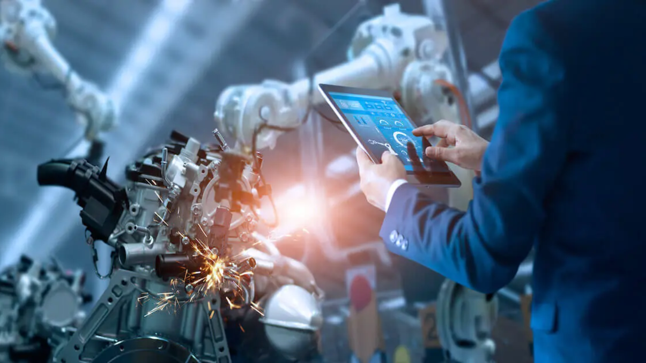 Engineer, in, blue, holding, an, ipad, working, on, machinery