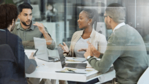 Meeting,,collaboration,and,business,people,in,discussion,in,the,office, 4 Business People At Table Discussing Workforce Planning Analytics