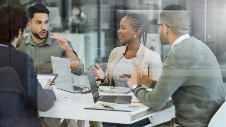 Meeting,,collaboration,and,business,people,in,discussion,in,the,office, 4 Business People At Table Discussing Workforce Planning Analytics
