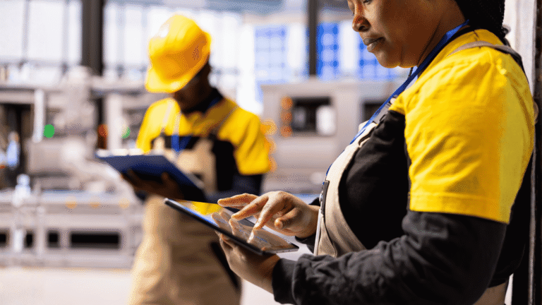 Two Engineers Using Factory Floor Technology Illustrating Technology Accessibility