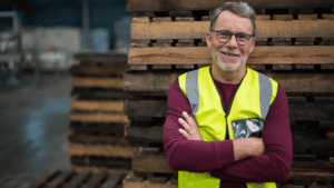 Industrial Worker Standing Next To Wooden Pallets; Job Bidding; Shift Bidding