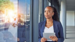 Happy Woman With Tablet, Looking At Window, Smiling, Hr Digital Transformation