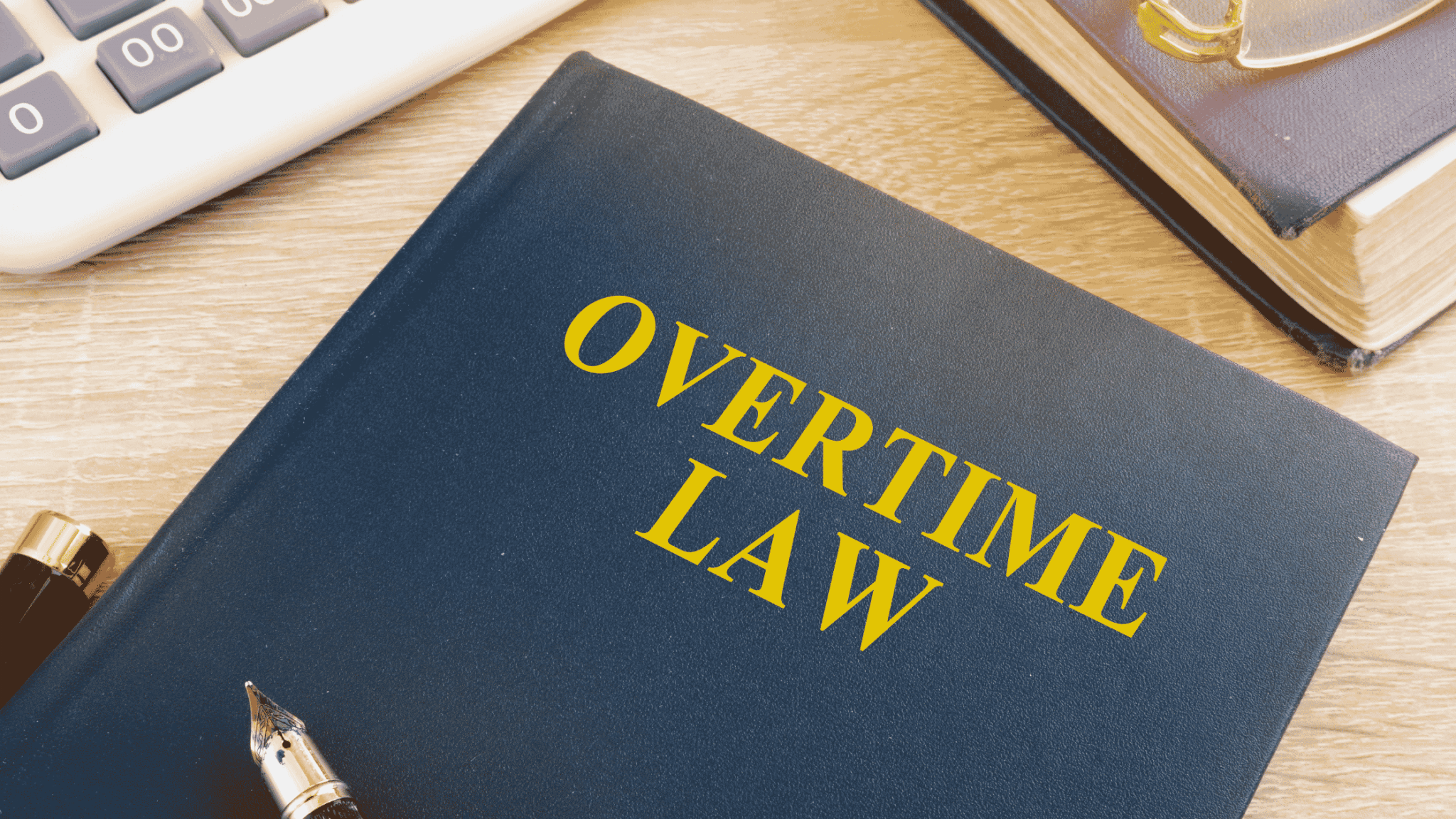 Mandatory Overtime Laws Book And Calculator In An Office